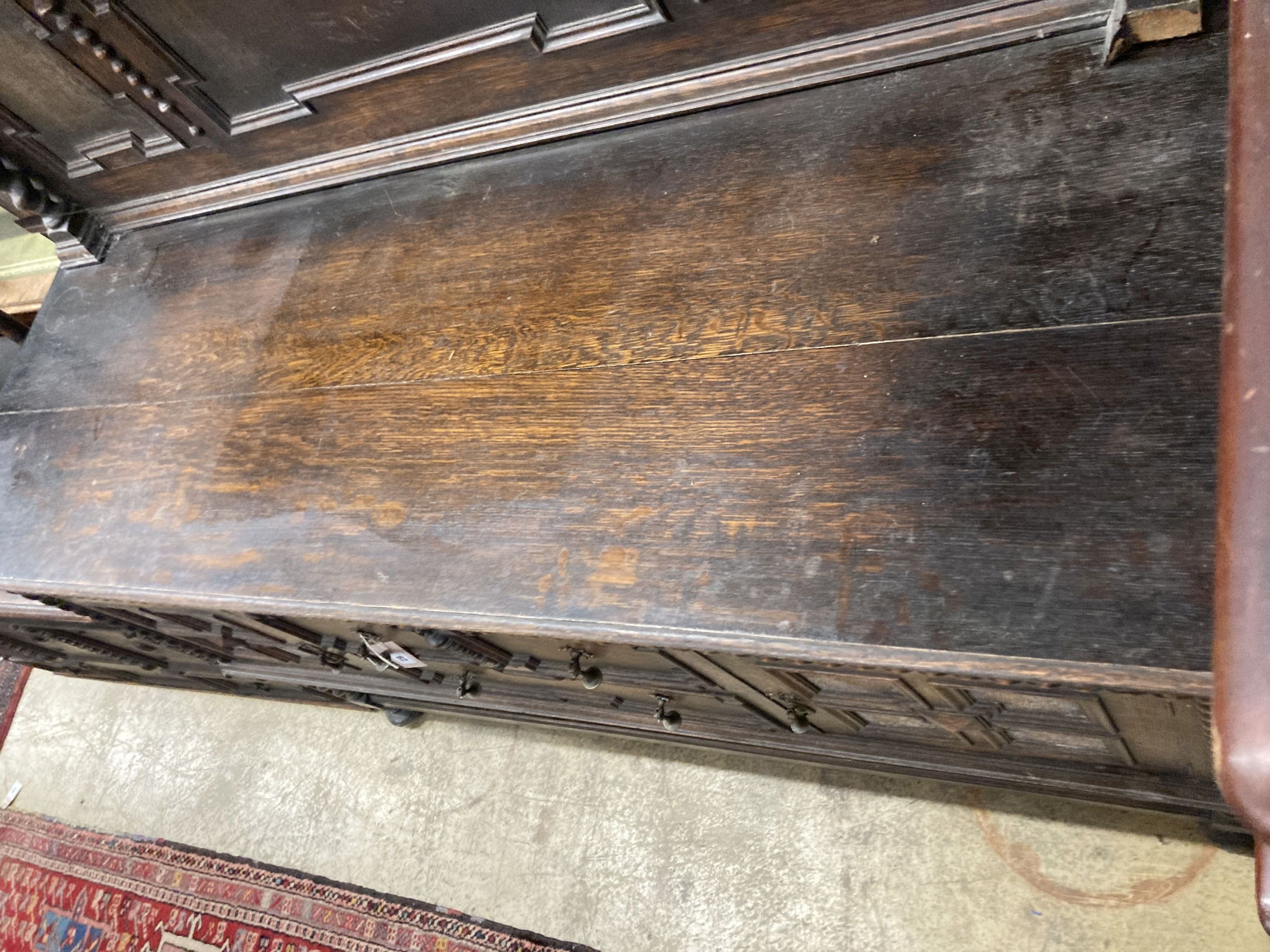 A 1920s Jacobean style oak sideboard, length 152cm, depth 56cm, height 144cm